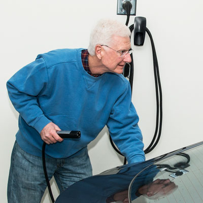 Tom Prout Fueling his Tesla Electric